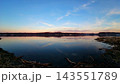 Calm Waterway at Dusk With Distant Shoreline 143551789