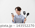 女性がスマホでレシピを確認しているイメージ 143552270