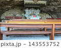 Interior view of the historic Wildkirchli cave chapel with wooden benches and stone altar inside a mountain cave in the Alpstein region, Switzerland 143553752