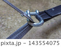 Metal shackle connecting tie-down straps for secure cargo restraint and transport safety 143554075