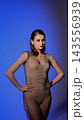 Beautiful woman posing with studio light, blue, purple background 143556939