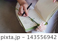 Open journal with a pink carnation and pen. Thoughts, memories and romantic notes. 143556942