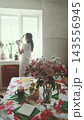 Woman with a fluffy dog in a bright kitchen. Companionship and happy pet ownership. 143556945