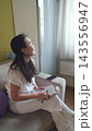 Thoughtful woman looking away from her journal. Inspiration, dreams and inner dialogue. 143556947
