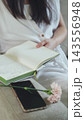Notebook, phone and carnation on a sofa, top view. Balance between digital and real life. 143556948
