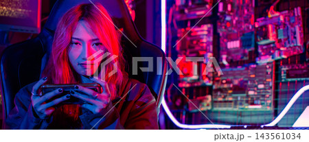 woman live stream she play video game at home neon lights living room 143561034