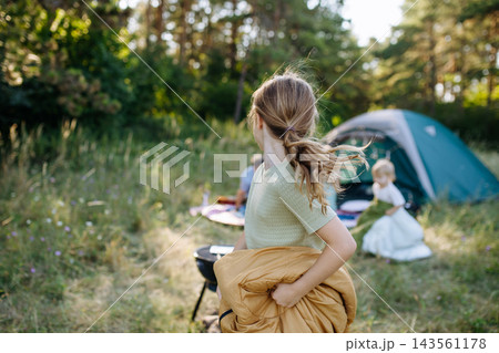 Happy family spending time together during summer camping trip. Happy family spending time together during summer camping trip. 143561178
