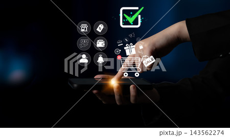 Hand Holding Smartphone with Shopping Cart and Icons Representing Online Shopping, E-commerce and Digital Payment Concept Background Quark Hand Holding Smartphone with Shopping Cart and Icons Representing Online Shopping, E-commerce and Digital Payment Concept Background Quark 143562274