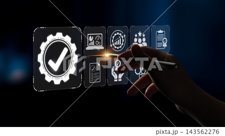 A hand interacting with digital quality management icons, symbolizing innovation and success in business strategies and performance optimization on a sleek abstract background. Sigmoid A hand interacting with digital quality management icons, symbolizing innovation and success in business strategies and performance optimization on a sleek abstract background. Sigmoid 143562276