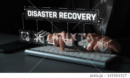 An engaged professional focuses on disaster recovery solutions through technology, featuring keyboard work and various icons symbolizing data protection and innovation. Sigmoid An engaged professional focuses on disaster recovery solutions through technology, featuring keyboard work and various icons symbolizing data protection and innovation. Sigmoid 143563327
