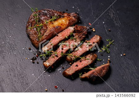 Seared barbecue steak served with aromatic herbs - beside fresh herbs Seared barbecue steak served with aromatic herbs - beside fresh herbs 143566092