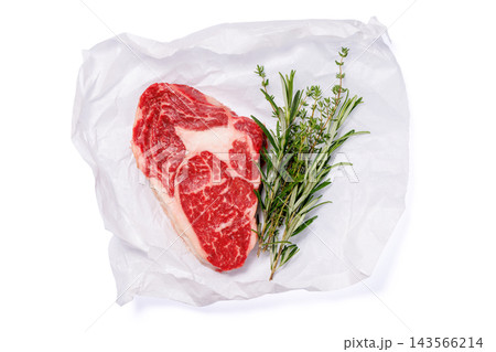 Butcher cut beef with salt pepper and fresh thyme - on parchment paper 143566214