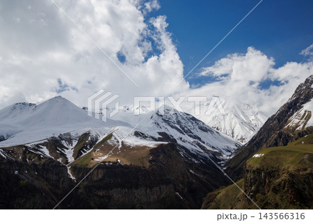 Snow covered mountains under blue sky 143566316