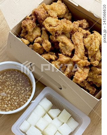 Crispy Korean fried chicken, perfectly glazed with a sweet and spicy sauce. Ideal for food photography and menus, showcasing the irresistible crunch and flavor of this beloved dish. 143566610