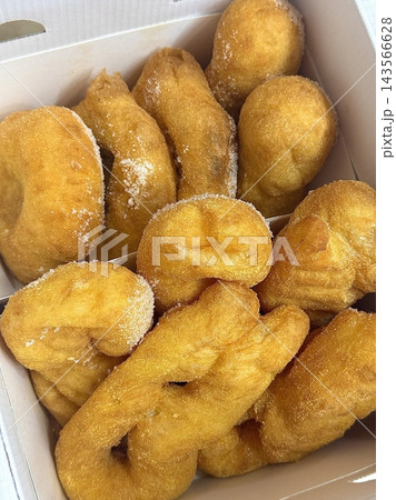 Golden and crispy kkwabaegi, Korean twisted donuts with a soft, fluffy interior, coated in sugar and cinnamon. A sweet and chewy treat perfect for snacking or dessert. 143566628