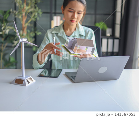 Beautiful engineer working in office design eco friendly and sustainable living home. Beautiful engineer working in office design eco friendly and sustainable living home. 143567053