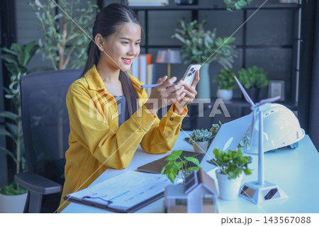 Beautiful engineer working in office design eco friendly and sustainable living home. 143567088