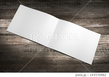 A4 to A5 brochure mockup with wooden desks in background 143570462