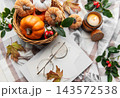 Autumn flat lay with pumpkins, candle, and warm blanket 143572538