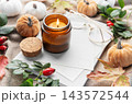 Lit candle creating cozy autumn hygge mood 143572544