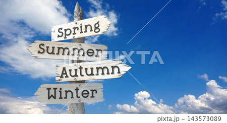 Spring, Summer, Autumn, Winter - wooden signpost with four arrows Spring, Summer, Autumn, Winter - wooden signpost with four arrows 143573089