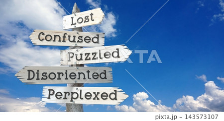 Lost, confused, puzzled, disoriented, perplexed - wooden signpost with five arrows 143573107