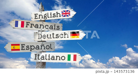 English, French, German, Spanish, Italian - wooden signpost with five arrows 143573136