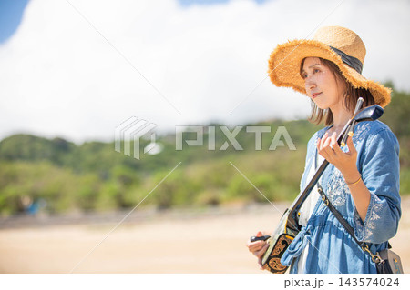 麦わら帽子と三線で佇む女性モデル 143574024