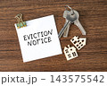 Eviction Notice paper note with keys and tiny house on wooden background, real estate and housing law concept 143575542