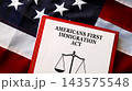 Americans First Immigration Act document with scales of justice on USA flag background, federal immigration law concept 143575548