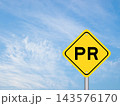 Yellow transportation sign with word PR (Abbreviation of purchase requisition or public relations) on blue color sky background 143576170