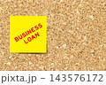 Yellow note paper with word business loan on cork board background with copy space 143576172