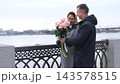 Couple exchanging roses on a spring promenade. Gratitude, care and a happy marriage. 143578515