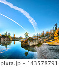 Amazing autumn view of  Lake Federa  at sunrise with majestic rocky mount and colorful trees glowing sunlight in Dolomites 143578791