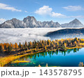 Amazing  aerial view of  crystal clear Lake Federa in Dolomites Alps under sunlight in mist and fog. 143578795