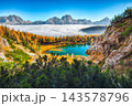 Breathtaking  aerial view of  crystal clear Lake Federa in Dolomites Alps under sunlight in mist and fog 143578796