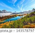 Breathtaking  aerial view of  crystal clear Lake Federa in Dolomites Alps under sunlight in mist and fog 143578797