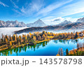 Amazing  aerial view of  crystal clear Lake Federa in Dolomites Alps under sunlight in mist and fog. 143578798