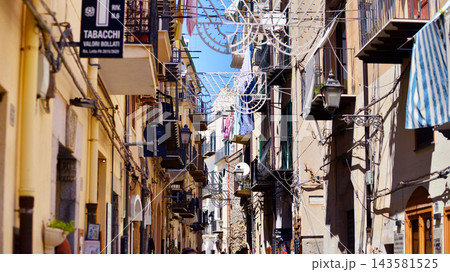 Cefalu, Italy. 21 August 2026. Buildings facade with balconies. Street at centre of old town. A view of typical Italian architecture. This an attractive destination in Sicily. 143581525