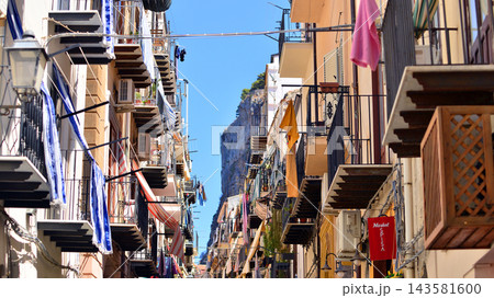 Cefalu, Italy. 21 August 2026. Buildings facade with balconies. Street at centre of old town. A view of typical Italian architecture. This an attractive destination in Sicily. Cefalu, Italy. 21 August 2026. Buildings facade with balconies. Street at centre of old town. A view of typical Italian architecture. This an attractive destination in Sicily. 143581600