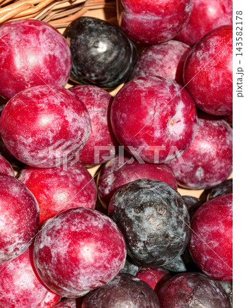 Plums displayed on grocery store shelves showcase fresh stone fruit with smooth skin, juicy flesh, natural sweetness, vitamins and beneficial antioxidant compounds 143582178