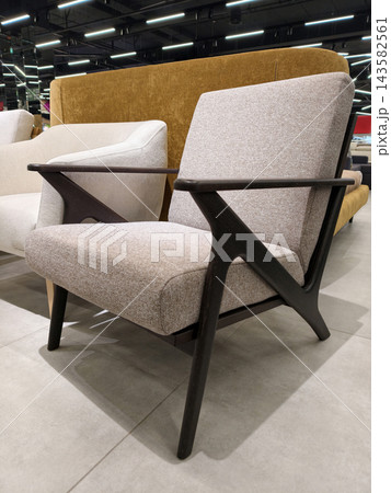 Soft armchair with wooden armrests for sale in the furniture supermarket Soft armchair with wooden armrests for sale in the furniture supermarket 143582561