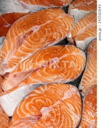 Fresh red fish fillet displayed on ice in a supermarket showcases chilled trout prepared for customers and presented in a clean seafood counter Fresh red fish fillet displayed on ice in a supermarket showcases chilled trout prepared for customers and presented in a clean seafood counter 143582643