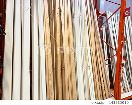 Timber planks and decorative mouldings in building supply store Timber planks and decorative mouldings in building supply store 143583010