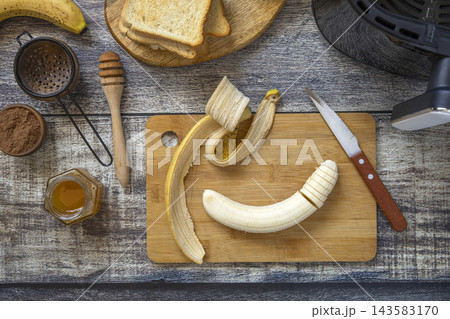 Step 3. Cooking toast bread with peanut butter and fried banana in an air fryer, in kitchen gadget modern. Lifestyle trendy of new cooking. Healthy cooking with air fryer. Step 3. Cooking toast bread with peanut butter and fried banana in an air fryer, in kitchen gadget modern. Lifestyle trendy of new cooking. Healthy cooking with air fryer. 143583170
