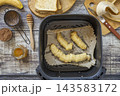 Step 5. Cooking toast bread with peanut butter and fried banana in an air fryer, in kitchen gadget modern. Lifestyle trendy of new cooking. Healthy cooking with air fryer. 143583172