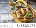 Delicious homemade toast bread with peanut butter and fried banana on wooden background. Healthy cooking with air fryer. Lifestyle trendy of new cooking. Copy space. 143583175