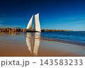 A sailboat with white sails in the beach of the Baltic sea 143583233