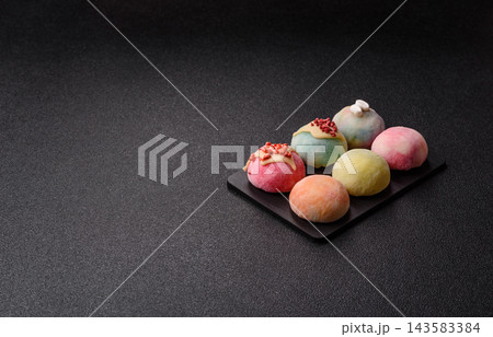 Asian Japanese mochi dessert in various colors and fruit flavors. Mochi dessert Asian Japanese mochi dessert in various colors and fruit flavors. Mochi dessert 143583384