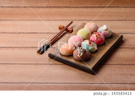 Asian Japanese mochi dessert in various colors and fruit flavors. Mochi dessert Asian Japanese mochi dessert in various colors and fruit flavors. Mochi dessert 143583413
